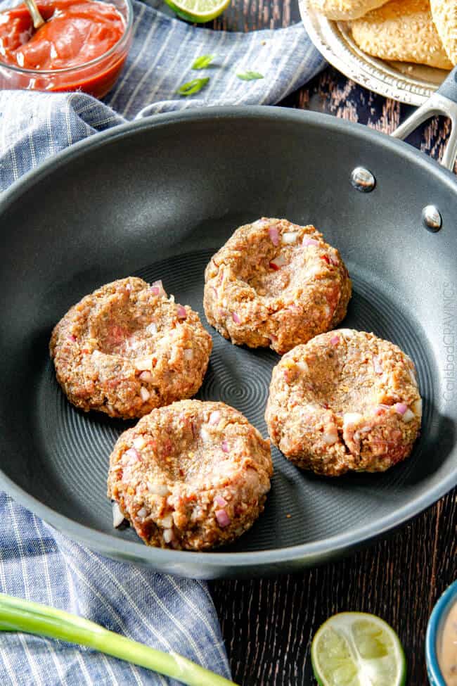 Showing how to make Asian Burger with Hoisin Ketchup & Garlic Chili Mayo by cooking the burgers in a pan.