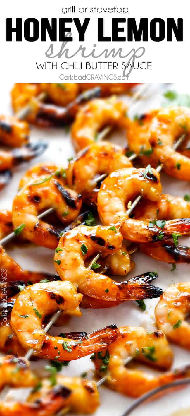 up close of Honey Garlic Shrimp on skewers on white parchment paper