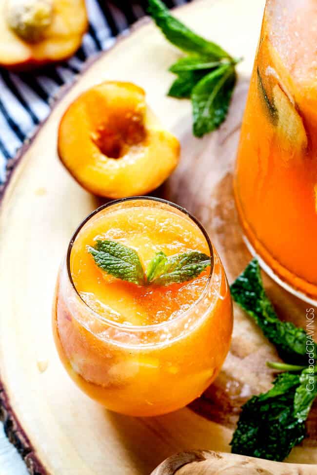 A glass cup full of Sparkling Peach Punch.