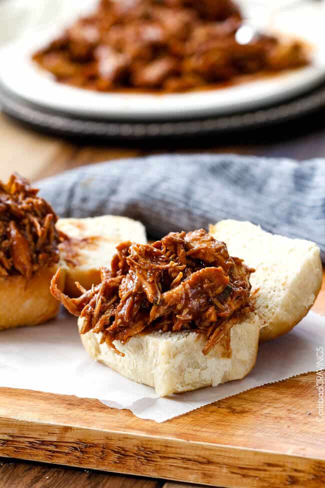 two open faced bbq pulled chicken sliders on parchment paper