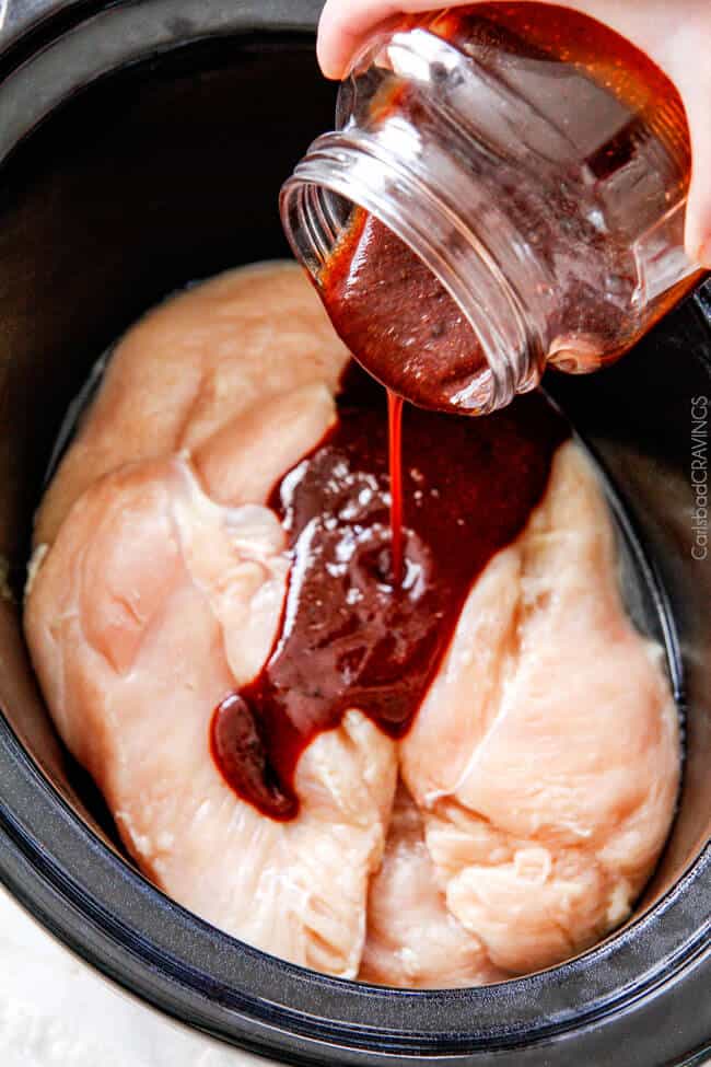 homemade barbecue sauce for Crockpot BBQ Chicken pouring into slow cooker