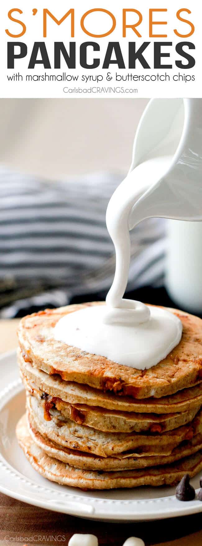 Fluffy S'mores Pancakes pouring marshmallow syrup over top. 