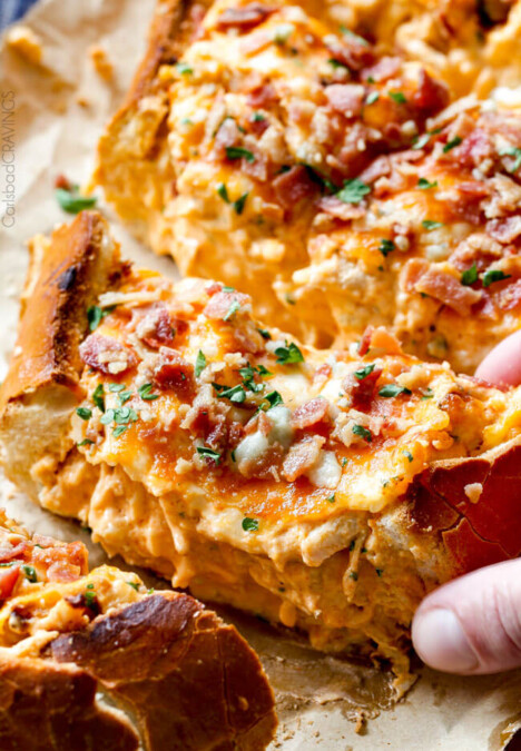 Mega flavorful Buffalo Chicken Dip Stuffed French Bread is your favorite cheesy dip baked right into the loaf! Crazy delicious side or EASY crowd pleasing appetizer! Everyone will be begging you to bring this!