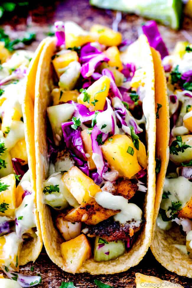 up close front view of easy Tilapia Fish Tacos with cabbage, avocados and cilantro