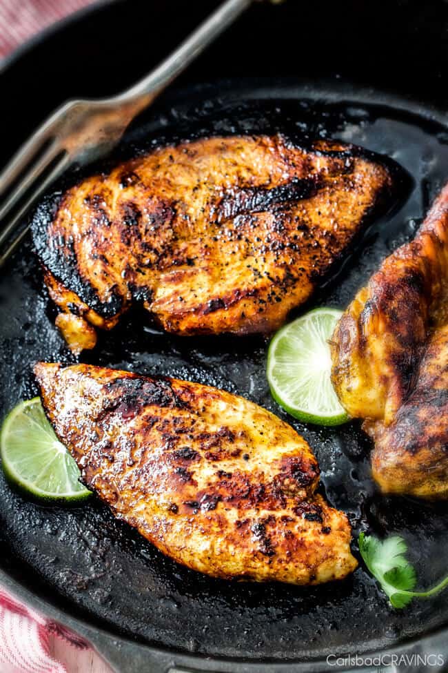 showing how to make chicken fajitas by searing chicken in a cast iron skillet
