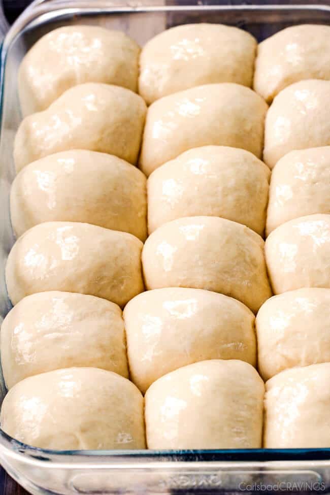A close up of raw dough form Hawaiian Sweet Rolls ready to be baked in a pan.