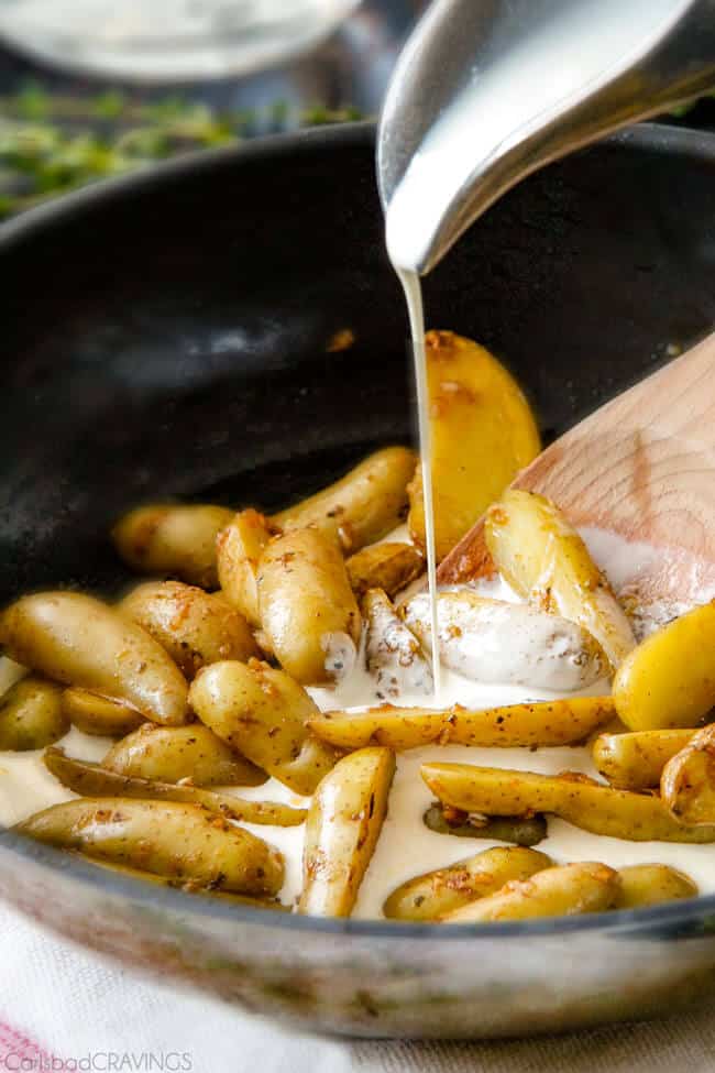 Showing how to make Maple Dijon Chicken Skillet by preparing the Fingerling Potatoes in a pan.