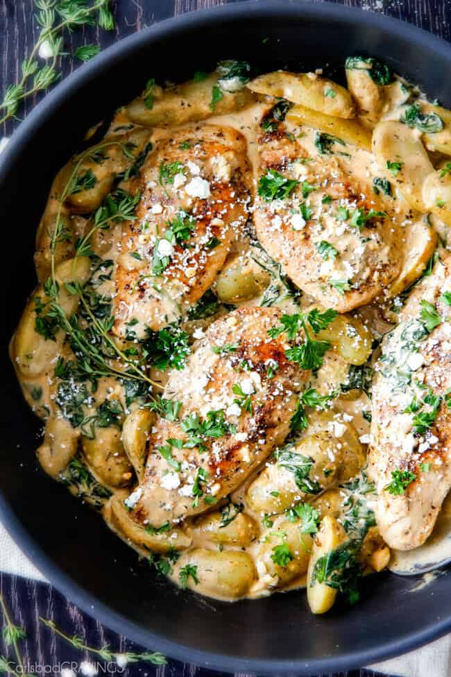 Top view of Maple Dijon Chicken Skillet with Fingerling Potatoes and Spinach in a pan.