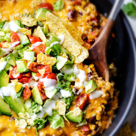 Creamy, Cheesy One Skillet Mexican Chicken and Rice on your table in 30 minutes! My family BEGS me to make this constantly and I LOVE it too! Quick, easy and packed with flavor and texture! We also love it as the base for taco salad. You definitely have to try this one!