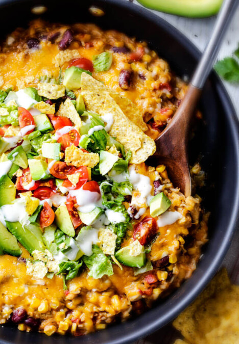 Creamy, Cheesy One Skillet Mexican Chicken and Rice on your table in 30 minutes! My family BEGS me to make this constantly and I LOVE it too! Quick, easy and packed with flavor and texture! We also love it as the base for taco salad. You definitely have to try this one!