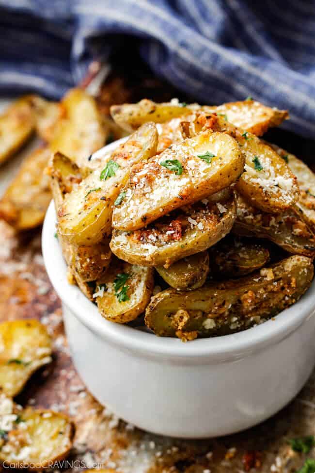Baked Parmesan Fingerling Potato Fries stacked high in a cup.