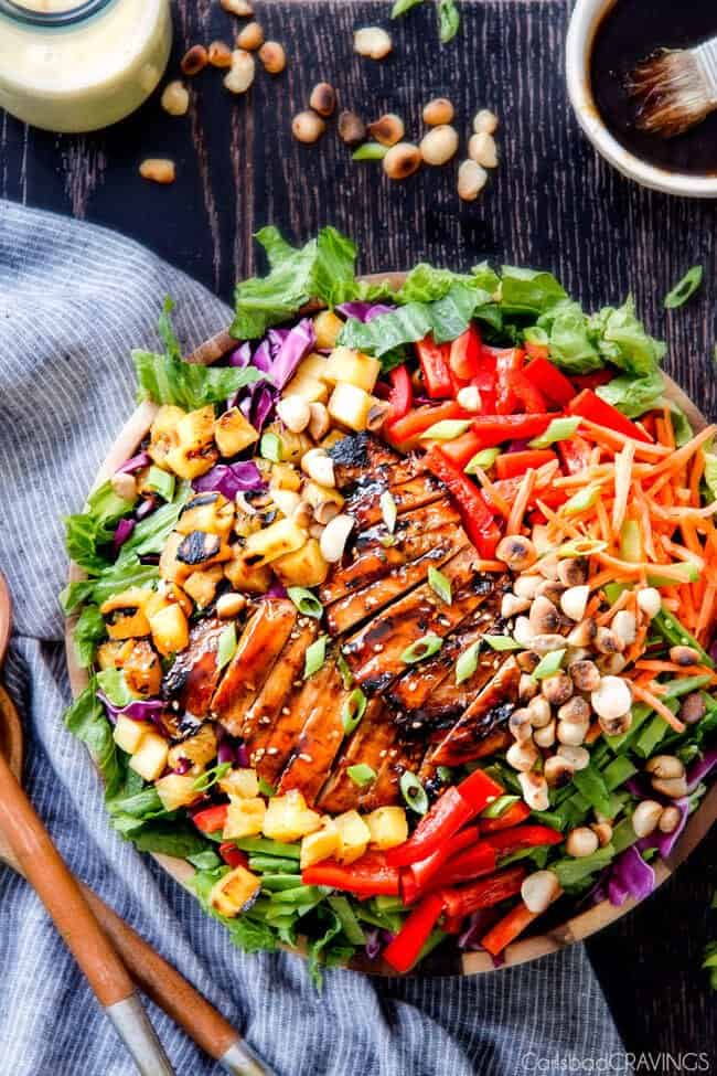 Teriyaki Chicken Salad - This salad is to live for! Packed with refreshing pineapple, macadamia nuts and coconut all doused with the most AMAZING Pineapple Sesame Dressing and the Sweet Chili Teriyaki Chicken is incredible! But my favorite part is you drizzle the leftover Teriyaki glaze all over the salad! Definitely a keeper!