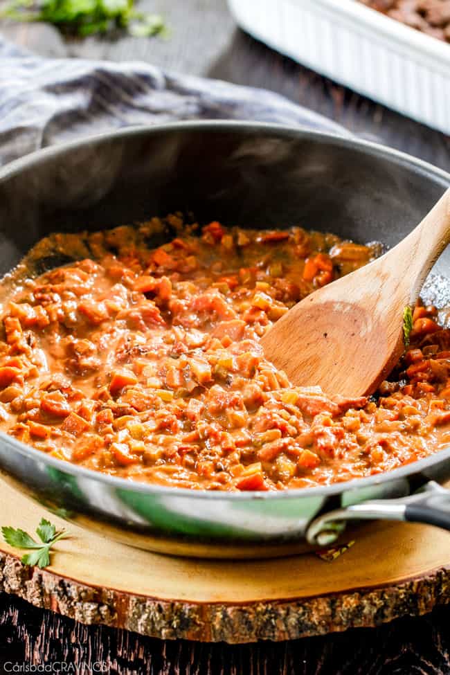 showing how to make Shepherd's Pie by cooking carrots, onions, celery in a skillet 