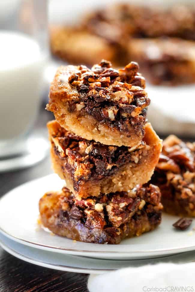 Chocolate Chunk Pecan Pie Bars stacked tall. 