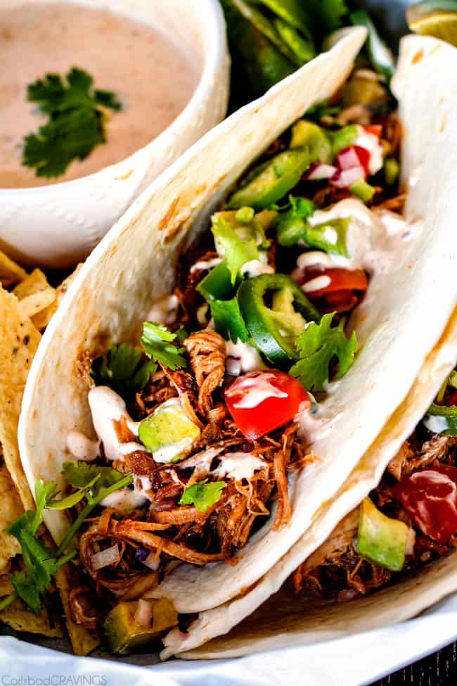 these are the BEST Pork Carnitas (Slow Cooker Mexican Pulled Pork) I have ever tried! Super juicy, easy and so much more flavorful than other versions I've tried and the crispy burnt ends are the best! Great for large crowds and for tacos, burritos, or nachos! 