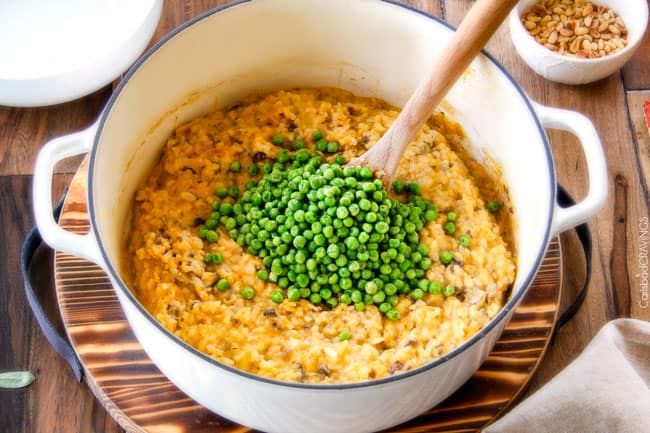 showing how to make Butternut Squash Risotto by stirring peas into risotto