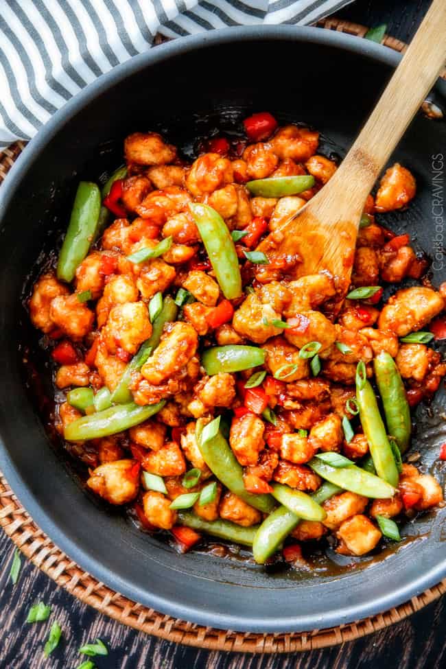 Hoisin Chicken Stir Fry in a large wok with a wooden spoon