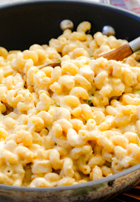 This mega creamy (lightened up) Salsa Verde Pepper Jack Macaroni and Cheese is crazy flavorful infused with salsa verde, pepper jack and sharp cheddar and super easy to make! A new family favorite on the table in under 30 minutes (including the option of chicken and veggies)!