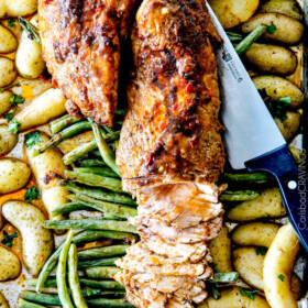 Sheet Pan Chili Dijon Pork Tenderloin with Green Beans and Potatoes all baked on ONE PAN! This is the most tender pork I have ever had and the tangy sweet and spicy flavors are out of this world!