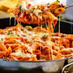 One Skillet Cheesy Penne - the best homemade ragu sauce simmered right with the pasta then loaded with cheese! My family begs me to make this weekly!