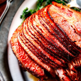 Baked Ham with Apple Cider Maple Glaze: beautifully caramelized, flavorful and deliciously moist baked ham takes minutes to prep and the glaze is out of this world! Perfect for Christmas, Easter and feeds a crowd!