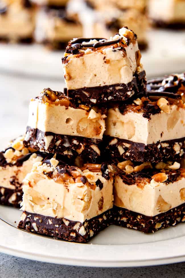 A close up tall stack of Chocolate Caramel Peanut Butter Fudge.