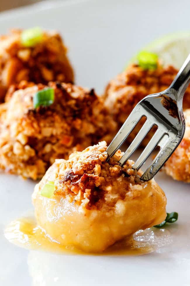 Baked Coconut Cashew Chicken Bites on a fork. 