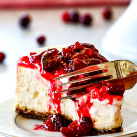 Cranberry Eggnog Cheesecake with Gingersnap Crust - this cheesecake is divine! Its become a family tradition because it tastes just like creamy eggnog and the Eggnog Cream Topping and Cranberry Topping make this worlds better than any other I've tried! A must for Christmas!