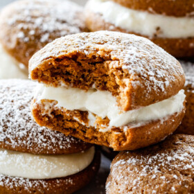 Gingerbread Whoopie Pies - everyone always begs me for this recipe! Super soft gingerbread cookies stuffed with luscious cream cheese filling! You won't be able to have just one!