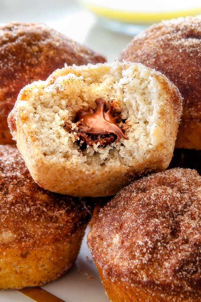 Close up of a Nutella Stuffed Snickerdoodle Muffins with a bite. 