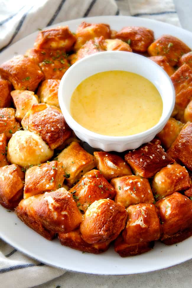 monkey bread made in a bundt pan on a white platter with dip