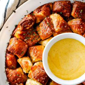 Soft, buttery Pretzel Monkey Bread with the most addicting Honey Mustard Dip! I always bring this crowd pleasing appetizer to parties and it is the first to go!