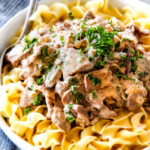 This is by far my family's favorite Slow Cooker Beef Stroganoff recipe! An ultra rich and creamy, amazingly flavorful sauce (without any "cream of" anything!), crazy tender meat all made in the crockpot for a gourmet meal with hardly any effort! I love serving this for holidays like Christmas!