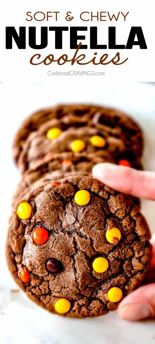 up close of holding chewy Nutella cookies with Reese's pieces