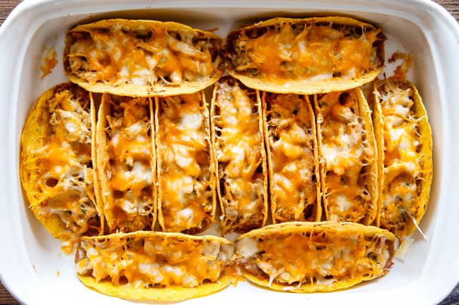 Showing how to make Ranch Chicken Tacos piled with refried beans, cheese after baking. 