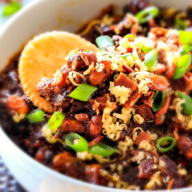 Super easy Boston Baked Bean Dip piled with bacon, cheese, sour green and green onions for your favorite sweet and tangy beans in savory scoop form! Always a crowd pleasing appetizer!