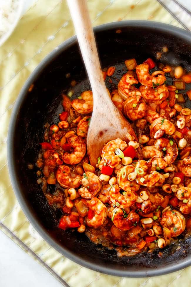 showing how to make Kung Pao Shrimp by stir frying shrimp with Kung Pao Sauce