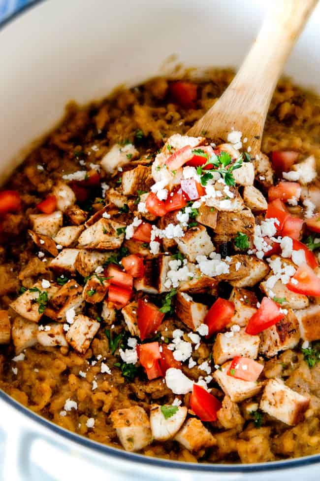 simple chicken risotto in a white pot garnished with parmesan