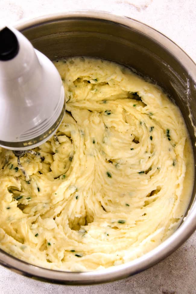 showing how to make best mashed potatoes recipe by mixing potatoes in a bowl with handheld mixer until creamy