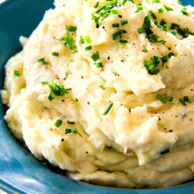 BEST EVER Creamy Company Mashed potatoes infused with butter, garlic, and Parmesan! I could eat these all day alone with a spoon - they are incredibly velvety, flavorful and so good everyone will beg you for the recipe!
