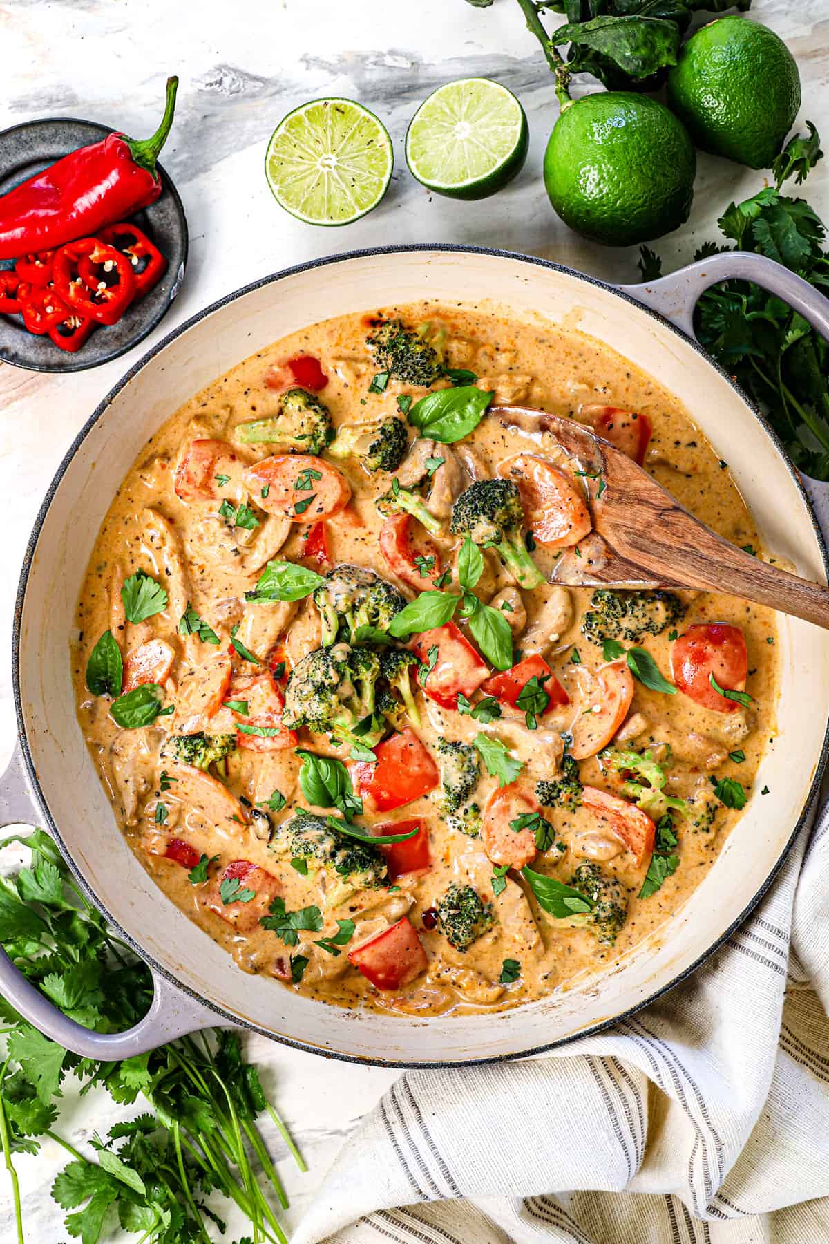 showing how to make Thai curry chicken recipe by garnishing with cilantro and lime juice