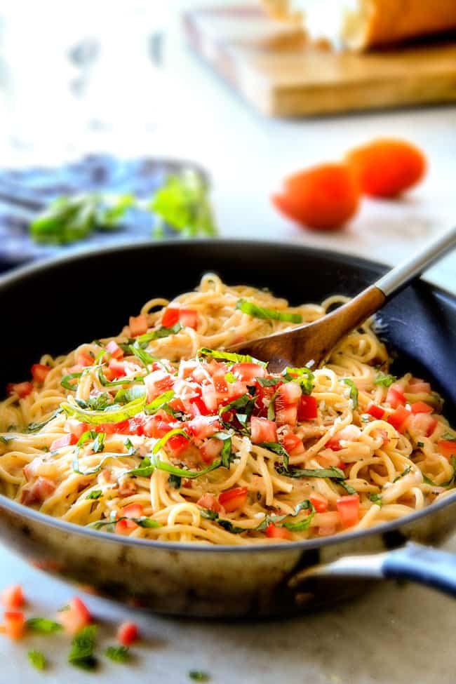 20 Minute LIGHTENED UP Margherita Pasta bursting with fresh tomatoes and basil in a garlic, mozzarella Parmesan sauce! your favorite Margherita pizza in creamy pasta form!