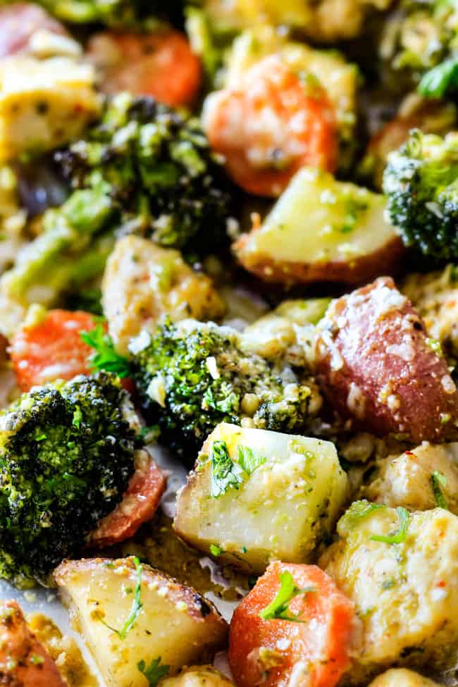 Detailed image showing baked Sheet Pan Parmesan Pesto Chicken with Potatoes, Broccoli and Carrots.