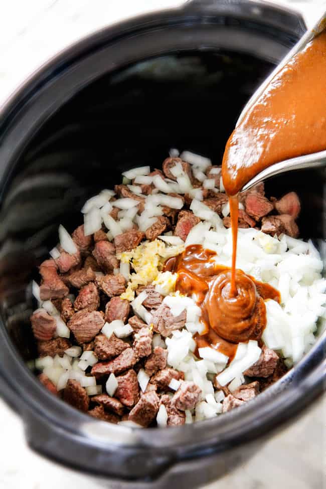 Showing how to make Crock Pot Beef Tips Recipe by adding seared meat, onions and gravy to slow cooker