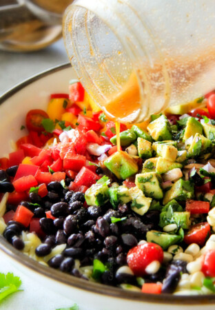 This Southwest Orzo Salad is SO good I was craving it for days! Its my new go-to potluck side loaded with mangoes, black beans, corn, peppers and avocado but the BEST part is the Chipotle Honey Lime Vinaigrette! And I love that you can make it ahead of time!