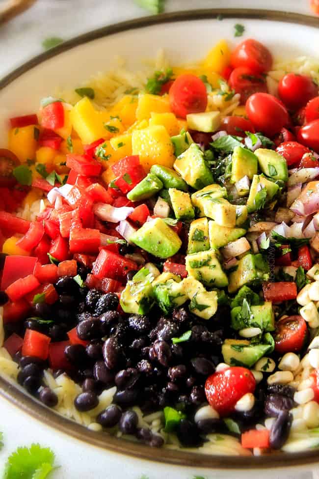  Orzo Salad in a white bowl with black beans, tomatoes, avocado