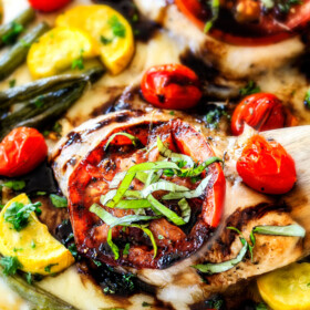 Sheet Pan Caprese Balsamic Chicken and Veggies - an easy, satisfying meal all in one! Wonderfully juicy, flavor bursting chicken smothered in gooey mozzarella cheese with fresh basil and the most incredible balsamic reduction!