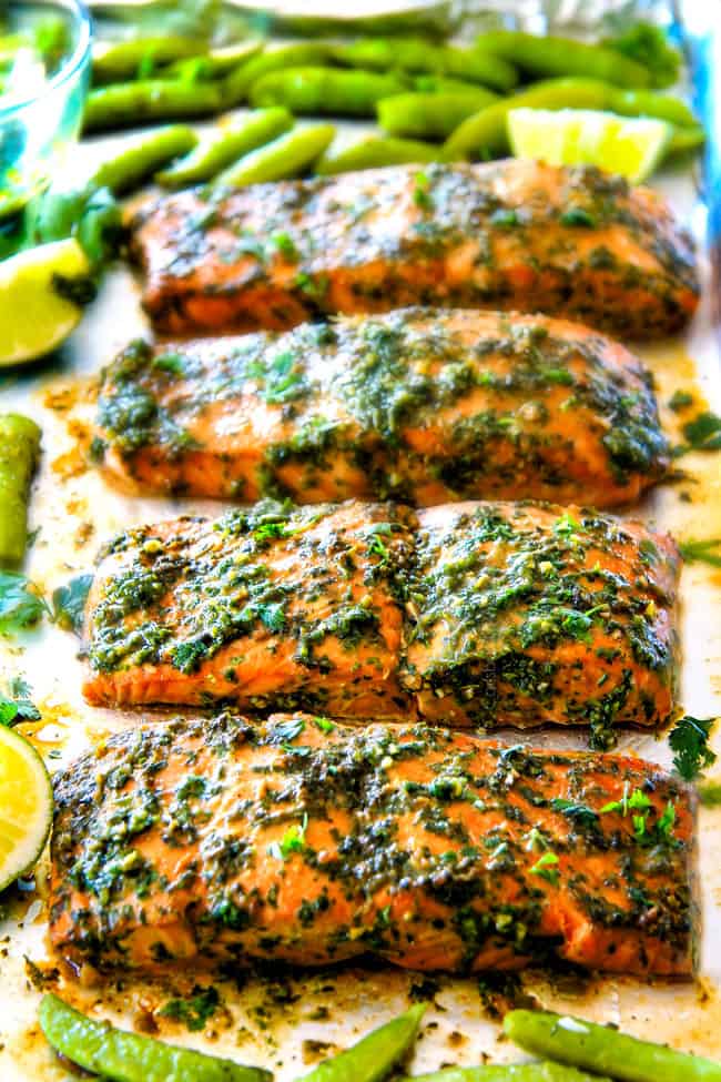 Several Asian Chimichurri Salmon on a pan with vegetables.
