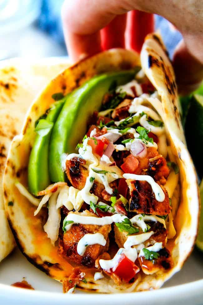 These are ADDICTINGLY DELICIOUS!  Honey Chipotle Chicken Tacos stuffed with wonderfully juicy, flavor packed Honey Chipotle Bacon Chicken (yes BACON chicken!), piled with crispy BLT Slaw and creamified with Cilantro Lime Crema!  