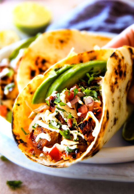 These are ADDICTINGLY DELICIOUS!  Honey Chipotle Chicken Tacos stuffed with wonderfully juicy, flavor packed Honey Chipotle Bacon Chicken (yes BACON chicken!), piled with crispy BLT Slaw and creamified with Cilantro Lime Crema!  